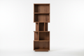 Tall walnut wood bookshelf with open shelves and warm brown tones
